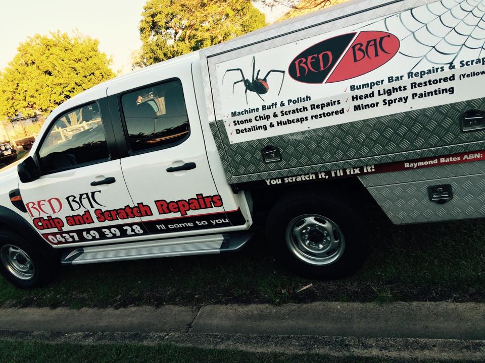 The Red Bac work ute in its full black and red livery with the redback spider logo and the service list along the toolbox