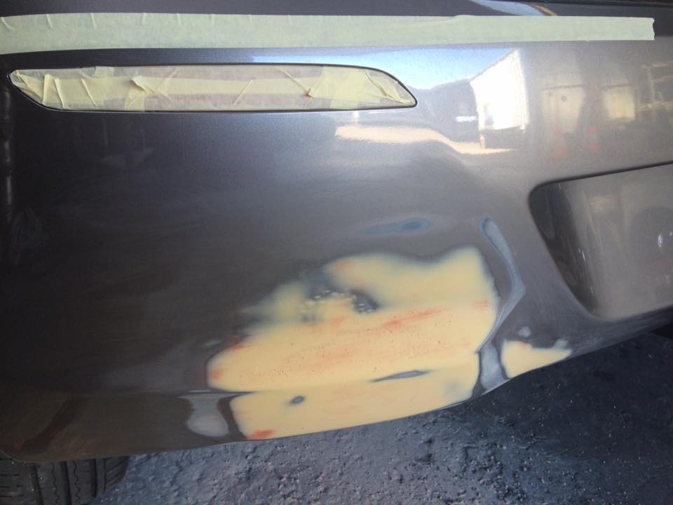 Rear quarter scrape, grey hatch: Filler worked into the scrape, tail light edge masked.
