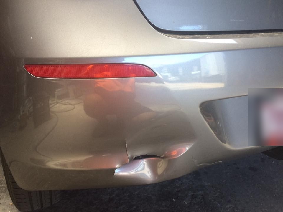 A split and cracked corner on a champagne coloured rear bumper