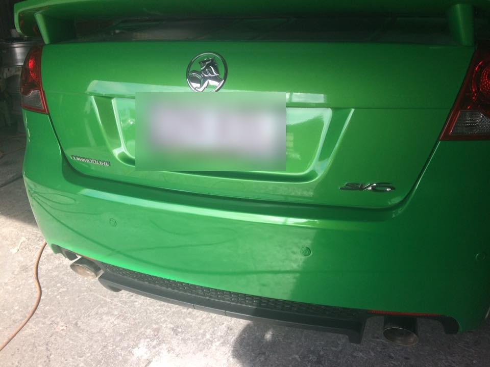 Rear bumper, green Commodore SV6: Colour laid on and cut back, the join gone under the gloss.